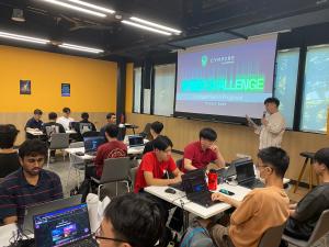 Teams of students on laptops engaged in a cyber competition