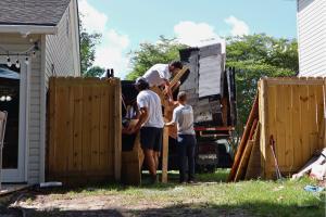 Black Dog Junk Removals team loading yard debris into the Black Dog junk truck.