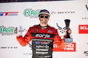 Matt Field wears a red and black uniform and stands with a trophy, marking NEFT Vodka's historic double podium at Formula DRIFT Utah