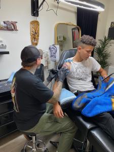 Jason “Elvis” Martin tattooing a client at Elvis Tattoo Shop, Hendersonville TN.
