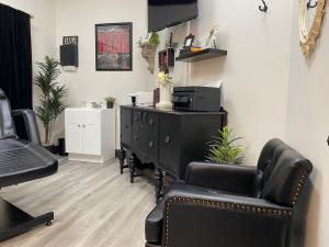 Private tattoo booth with chair, sink and plants at Elvis Tattoo Shop, Hendersonville TN.