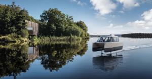 A Vessev VS-9 flying above the water alongside Finn Lough, a luxury forest hideaway on the shores of Lower Lough Erne in Northern Ireland (rendered image)