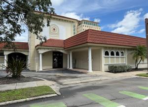 The front exterior of ALSO Youth’s new Sarasota Center building at 2195 Ringling Blvd in Sarasota, showing a tan structure with a red-tiled roof and white columns.