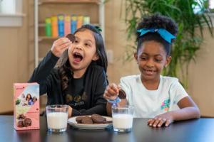 Two young Girl Scouts with new Exploremore cookie
