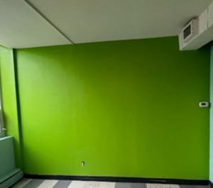 Close-up view of a finished soundproof wall, showing smooth surface and precise installation details