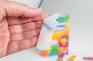 Close-up of BooBoo Cooler bandage showing the internal water bag that freezes to provide soothing cooling comfort for children.