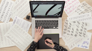 Graphic Designer rendering typography for branding project