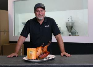 Founder Chris Abbott proudly stands behind Brined’s signature Turkey Mix—where culinary tradition meets bold flavor innovation.