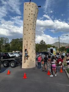UTVA student climbing a wall during back to school fair