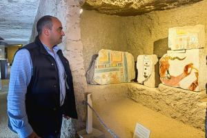 Dr. Mohamed Ismail Khaled gazes upon a collection of ancient Egyptian artifacts.