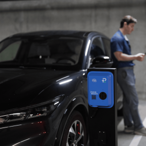 EV driver charging in a parking garage