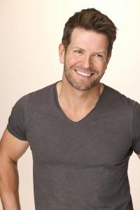 Wellness expert Gordon Fraser smiles broadly as looks off right.