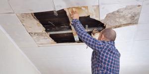 Ceiling flood damage being repaired by restoration experts, showcasing client-centered water damage services that identify hidden moisture and remove standing water.