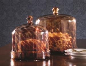Two tortoise shell design cake domes on table at Ballard Designs