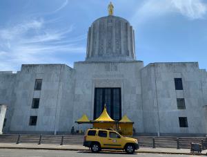 Portland Volunteer Ministers set up their bright yellow tent on the steps of the Oregon State Capitol.