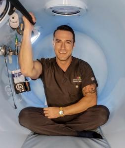 Dr. Alexander Borsand inside RX-O2 hyperbaric oxygen chamber, leader in HBOT safety and training.