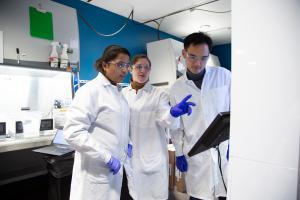Three scientists observing data collection at Allen Institute.