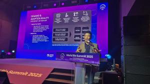 Zen KOH stands on stage presenting “From Pilots to Scale” at World Bio Summit 2025 in Seoul (17 Sept 2025), speaking on AI-enabled rehab and assistive robotics, with slides projected behind him.