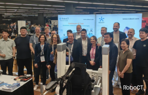 Group photo at RoboCT’s RehabWeek 2025 booth showing Dr. Wang Tian with Organising Committee members and the RoboCT team in front of branded displays.