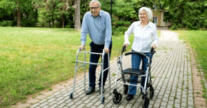 Happy senior couple walking outdoors with lightweight walkers, enjoying independence and safety.