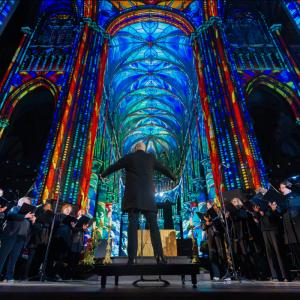 photo of a conductor and choir during a Luminiscence event