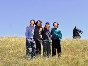 Pateka group photo in field with alien in background by by Sean Higley