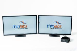 The picture shows twin monitors and a computer, which are powered using a single Ethernet Cable.
