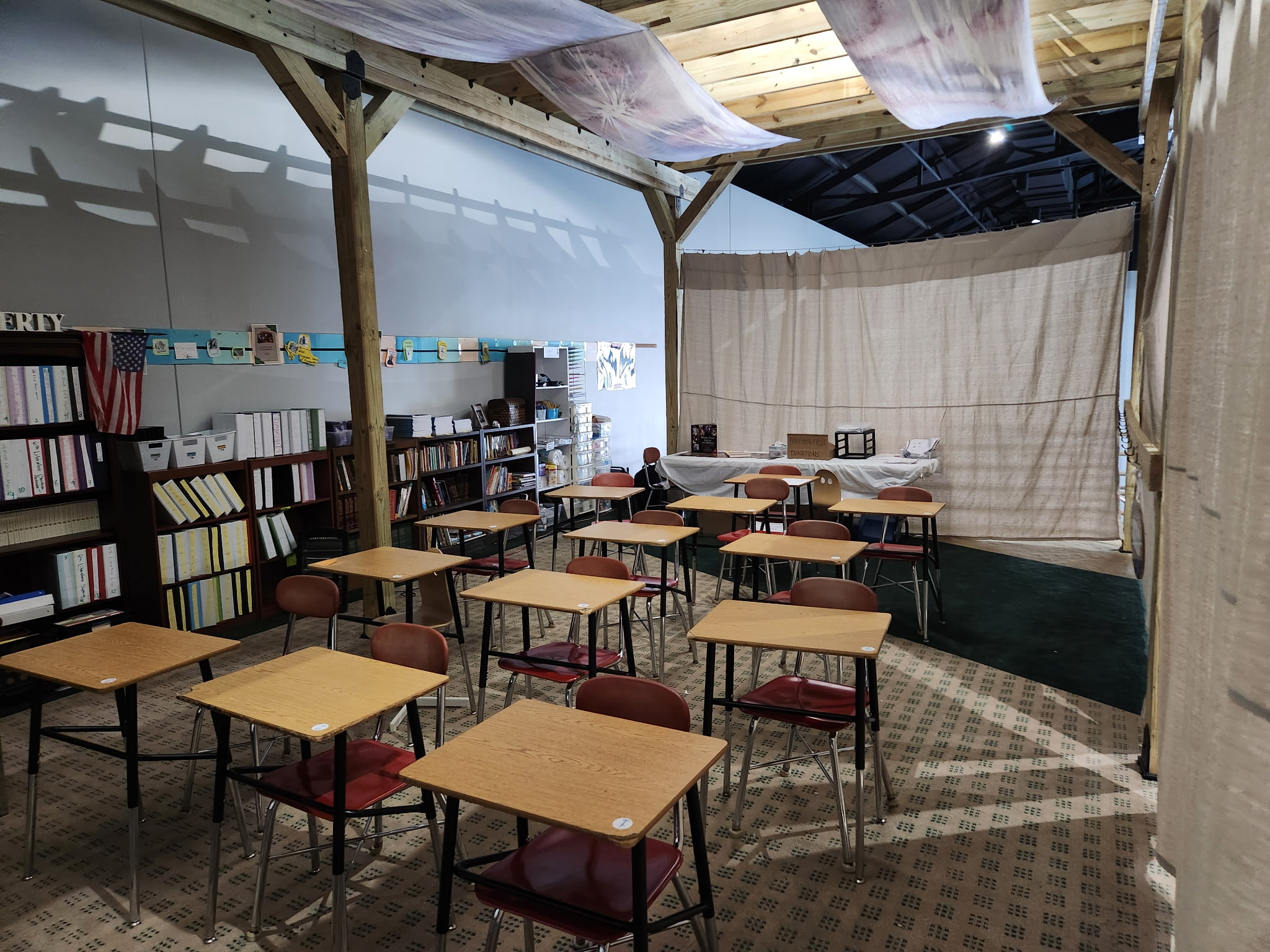 Classroom at Salt and Light Academy with desks and bookshelves, representing the school’s tuition-free Christian education and expansion needs.