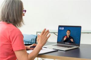A woman attending an online biomagnetism training class with Dr. Garcia demonstrating magnetic therapy using pairs of magnets.