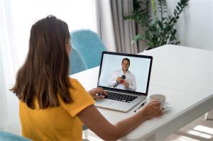 A participant engaging with Dr. Garcia during a live online biomagnetism workshop as he demonstrates magnet placement techniques.
