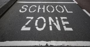 image of school zone painted on asphalt