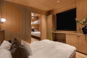 Interior of Roam Echo Island Cabin showing queen bed and two bunk beds