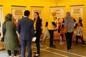 Scientology Volunteer Ministers Canadian Cavalcade welcomes visitors to its bright yellow pavilion.