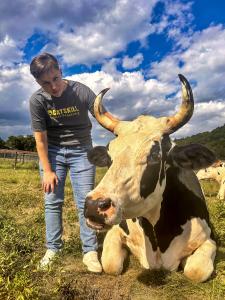 Sam, the new Executive Director of CAS, with Milton the cow.