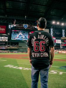 China Airlines President Kevin Chen stands on the field at Chase Field wearing a customized Diamondbacks jersey with his name and number 66, while Taiwan’s Taroko Sports introduction appears on the stadium’s big screen during the Opening Pitch ceremony.