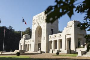 Picture of Lafayette Escadrille Memorial Cemetery with the two flags in front of it.  American Battle Monuments Commission.