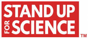 The phrase "Stand Up For Science" in red font over a white background, with "TM" trademark symbol in lower left corner. 