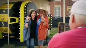 Couple celebrating on the CaskX bourbon investment wheel.