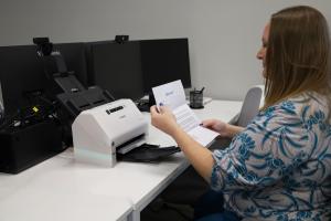 Heidi Hensell scanning documents into Stamp to Scan