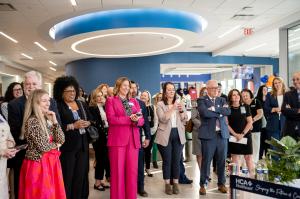 Attendees look on as Galen celebrates the grand opening.