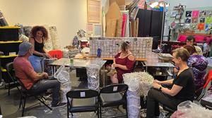Group of artists prepping shredded art