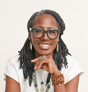 Dr. Makeba Morgan Hill smiling confidently, representing her Living4.Love™ brand as she unveils new offerings including a self-care guide, retreats, coaching programs, and podcasts.