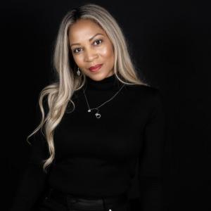 Dee Daniels blk background sitting color photo