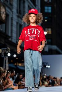 Noah Walker hits the runway in a red Levi's shirt ,matching cap ,and denim jeansat the Rookie USA X Macy's Fashion Show in New York City September 18, 2025