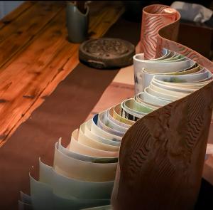 A hand-crafted scroll anthology representing the Aisin Gioro International Art Prize, created with traditional Chinese dragon-scale binding techniques and used as a permanent cultural archive