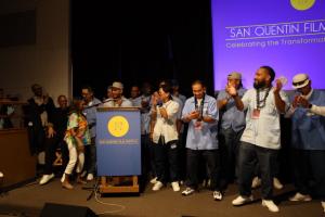 Winners of the SQFF24 Best Short Documentary celebrate onstage.