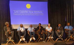 Kamau Bell moderates an onstage panel at SQFF24 with the six Best Short Film Finalists, all currently and formerly incarcerated filmmakers.