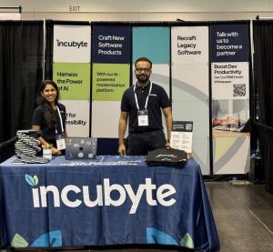 Incubyte founders standing at the company’s booth with branded displays and materials.