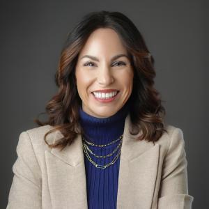 Janie smiling on dark gray background