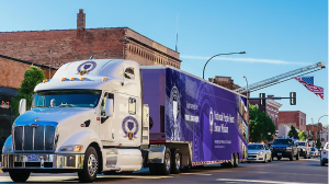 An exterior rendering of the National Purple Heart Traveling Tribute and Education Center arriving in a community as part of the Purple Hearts Across America Tour.